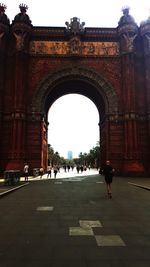 People walking in front of historical building