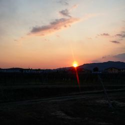 Scenic view of silhouette field against sky during sunset