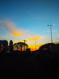 Silhouette of buildings against sky at sunset