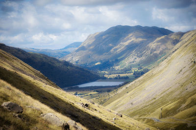 Scenic view of valley and mountains against sky