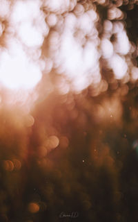 Defocused image of illuminated sea against sky