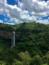 Scenic view of waterfall against sky