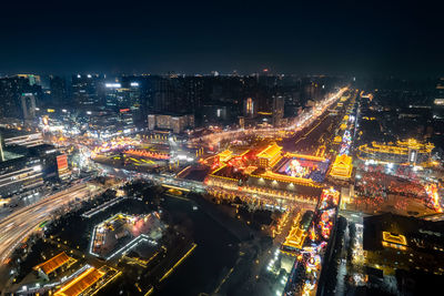 High angle view of illuminated buildings in city at night