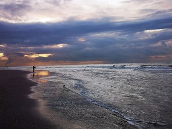 Scenic view of beach against sky during sunset
