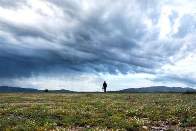 Man standing on field against sky