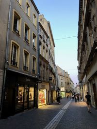 Street amidst buildings against sky in city