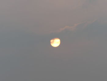 Low angle view of moon against sky at sunset