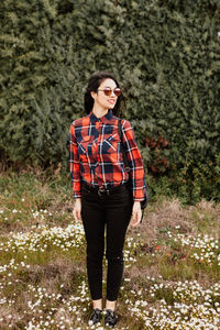 Full length of young woman standing on ground