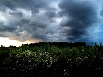 Scenic view of field against dramatic sky