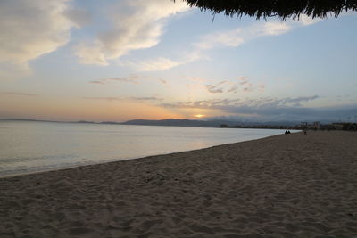 Scenic view of beach against sky during sunset