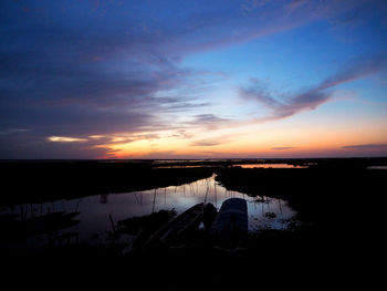 Scenic view of lake against sky during sunset