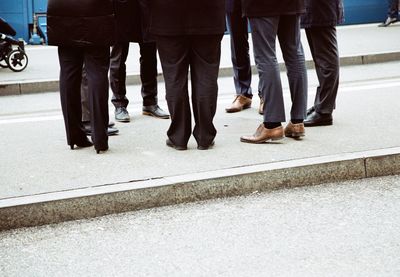 Low section of business people standing on road