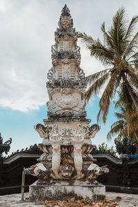 Low angle view of statue of building against sky