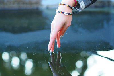 Hand touching water