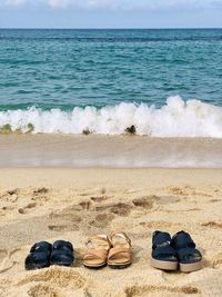 High angle view of shoes on sand at beach