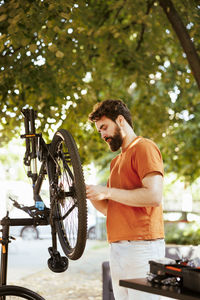 Side view of man riding bicycle