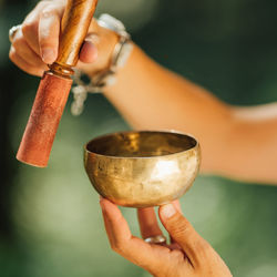 Tibetan singing bowl in sound healer hands outdoors