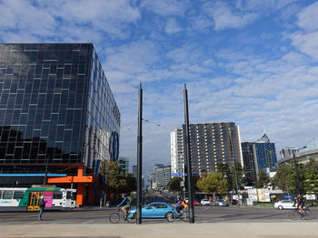 City street by buildings against sky