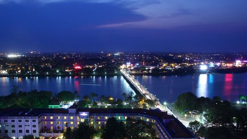 High angle view of city lit up at night