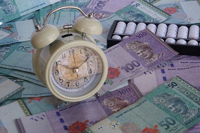 High angle view of clock on paper