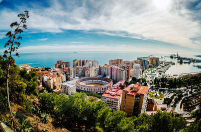 High angle view of plaza de toros de la malagueta against cloudy sky in city