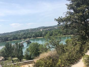 Scenic view of lake by trees against sky