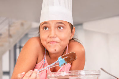 Cute girl preparing food at kitchen