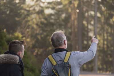 Rear view of man showing direction