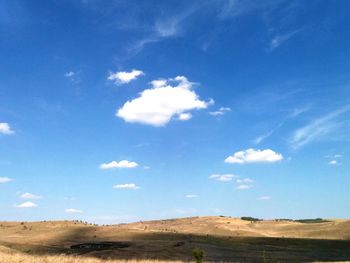 Scenic view of landscape against blue sky