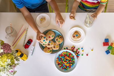 High angle view of children on table