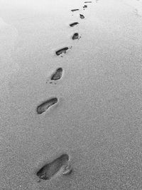 High angle view of footprints on sand at beach