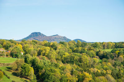 Scenic view of mountains against clear blue sky