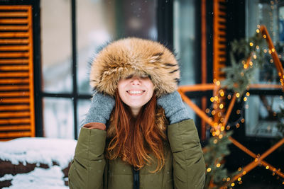 Cheerful woman wearing warm clothing during winter