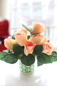 Close-up of roses in vase on table