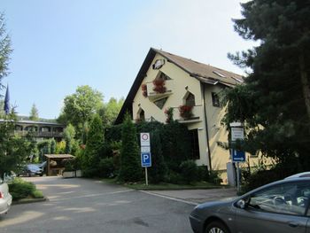 Road amidst trees and buildings against clear sky