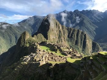 Aerial view of mountain range against cloudy sky