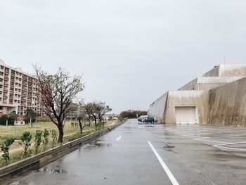 Road amidst buildings against sky in city