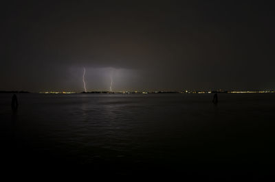 Scenic view of sea at night during thunderstorm