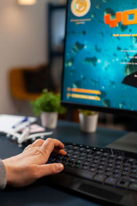 Midsection of person using laptop on table