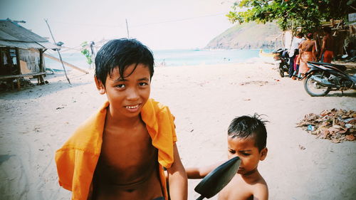 Portrait of shirtless boy on beach