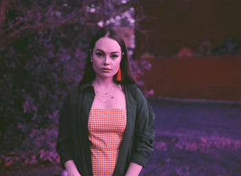 Portrait of beautiful young woman standing outdoors