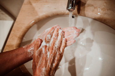 High angle view of person hand in bathroom