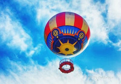Low angle view of hot air balloons against blue sky