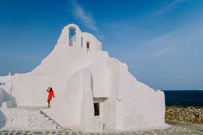 Panoramic view of white building by sea against blue sky