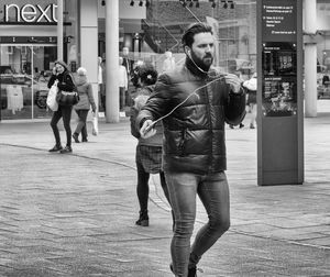 Full length of man walking on street in city