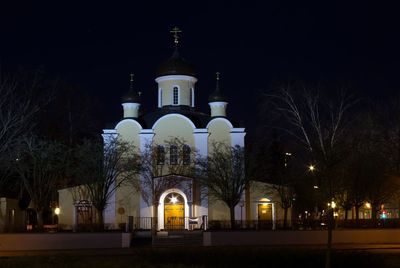 Illuminated cathedral against sky at night