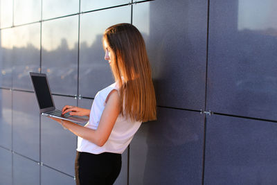Rear view of woman using mobile phone