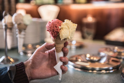 Cropped hand of person holding ice cream cone