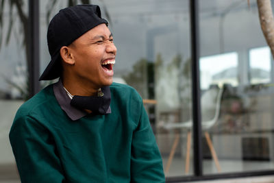 Man wearing hat looking away