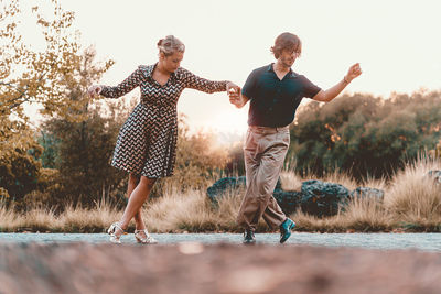 Couple holding hands on field